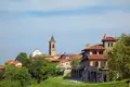 Panorama eines italienischen Dorfes mit Kirche und traditionellen Häusern.
