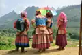 Vier Frauen in traditioneller Kleidung mit Blick auf die Berglandschaft.