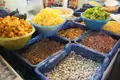 Auslage mit verschiedenen Trockenfrüchten und Nüssen auf einem Markt.