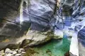 Enge Schlucht mit smaragdgrünem Wasserbecken.