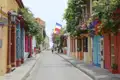 Farbenfrohe Häuserfassaden und blühende Pflanzen entlang einer Straße in Cartagena.