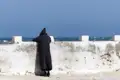 Person in traditioneller Kleidung am Meer