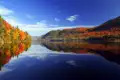 Herbstlandschaft mit See und buntem Laub