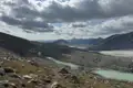 Gletscher und Fluss in einer bergigen Landschaft.