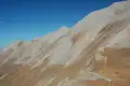 Felsiger Berghang mit sichtbaren Wanderwegen.