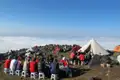 Wanderer essen im Basislager über den Wolken.