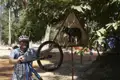 Radfahrer pausiert an einem Elefanten-Warnschild.