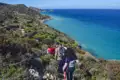 Wandergruppe auf einem Küstenpfad mit Blick auf das Meer.
