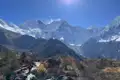 Wanderweg in den Bergen mit Blick auf schneebedeckte Gipfel.
