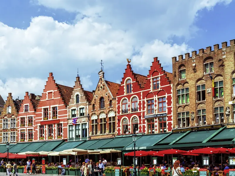 Blick auf den Marktplatz in Brügge: flämische Giebelhäuser, Straßencafés und Restaurants - Brügge ist der passende Ausgangspunkt für die Ausflüge auf unserer Reise.