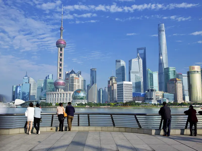 Bei Ihrem Stopp in der Hafenstadt Shanghai bummeln Sie auf unserer 15-tägigen Studienreise durch China über die Uferpomendae Bund und genießen den Blick auf die Wolkenkratzer-Skyline von Pudong.