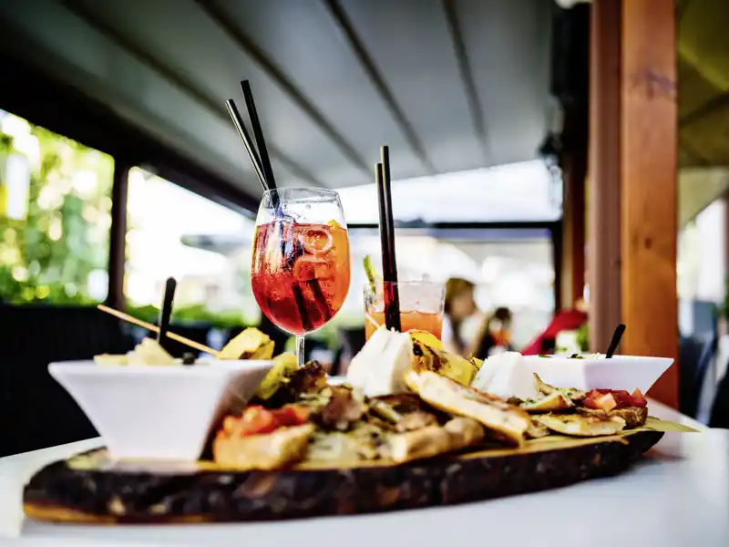 Abends in Palermo ist der Tisch für uns in einer Trattoria an der hübschen Piazza Marina gedeckt: Antipasti und Pizza sind so gut wie die Stimmung! Dazu vielleicht ein Nero d'Avola, einer der guten Tropfen der Insel?