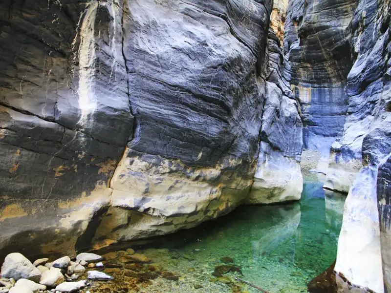 Enge Schlucht mit smaragdgrünem Wasserbecken.