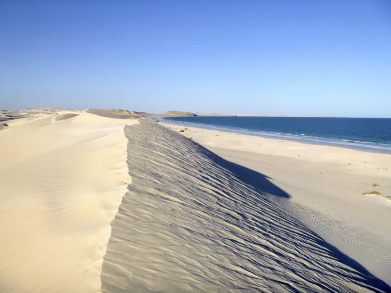 Sanddünen und Strand treffen aufeinander.
